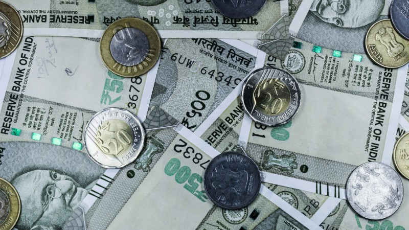 Top view of various Indian rupee banknotes and coins, highlighting financial themes., tags: domestic - pexel