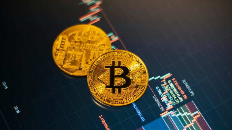 Golden Bitcoin coins on a digital stock market chart showcasing cryptocurrency trading., tags: financial - pexel