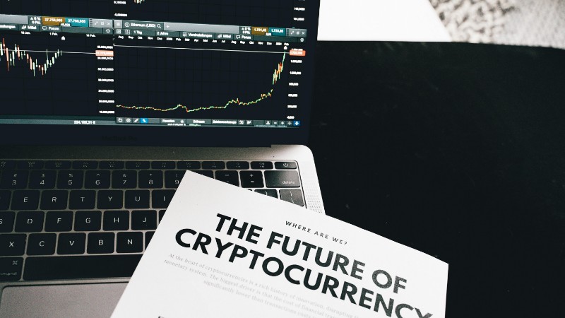 A detailed look at cryptocurrency market trends using a laptop and analytical document., tags: momentum - pexel