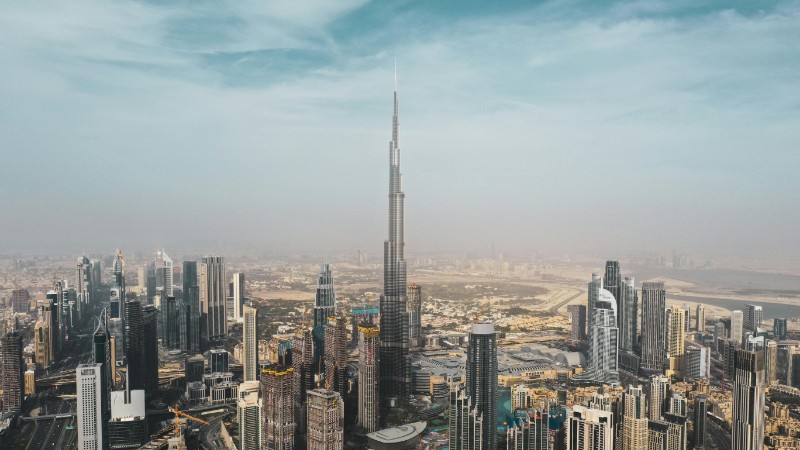 A breathtaking aerial view of Dubai's skyline featuring Burj Khalifa amidst modern skyscrapers under a clear sky., tags: gcc economies - pexel