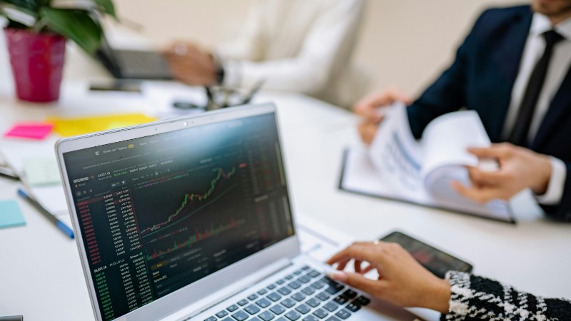 Business team analyzes cryptocurrency market trends using a laptop with graphs and data., tags: global - pexel