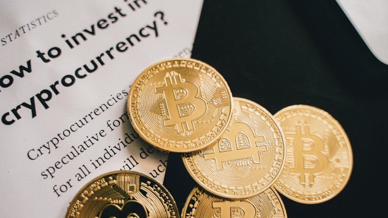 Close-up of Bitcoin coins alongside an investment guide in cryptocurrency., tags: market - pexel