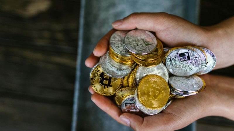 A close-up of hands holding various cryptocurrency coins, representing digital finance. - A close-up of hands holding various cryptocurrency coins, representing digital finance., tags: selling pressure crypto markets weekly - pexel